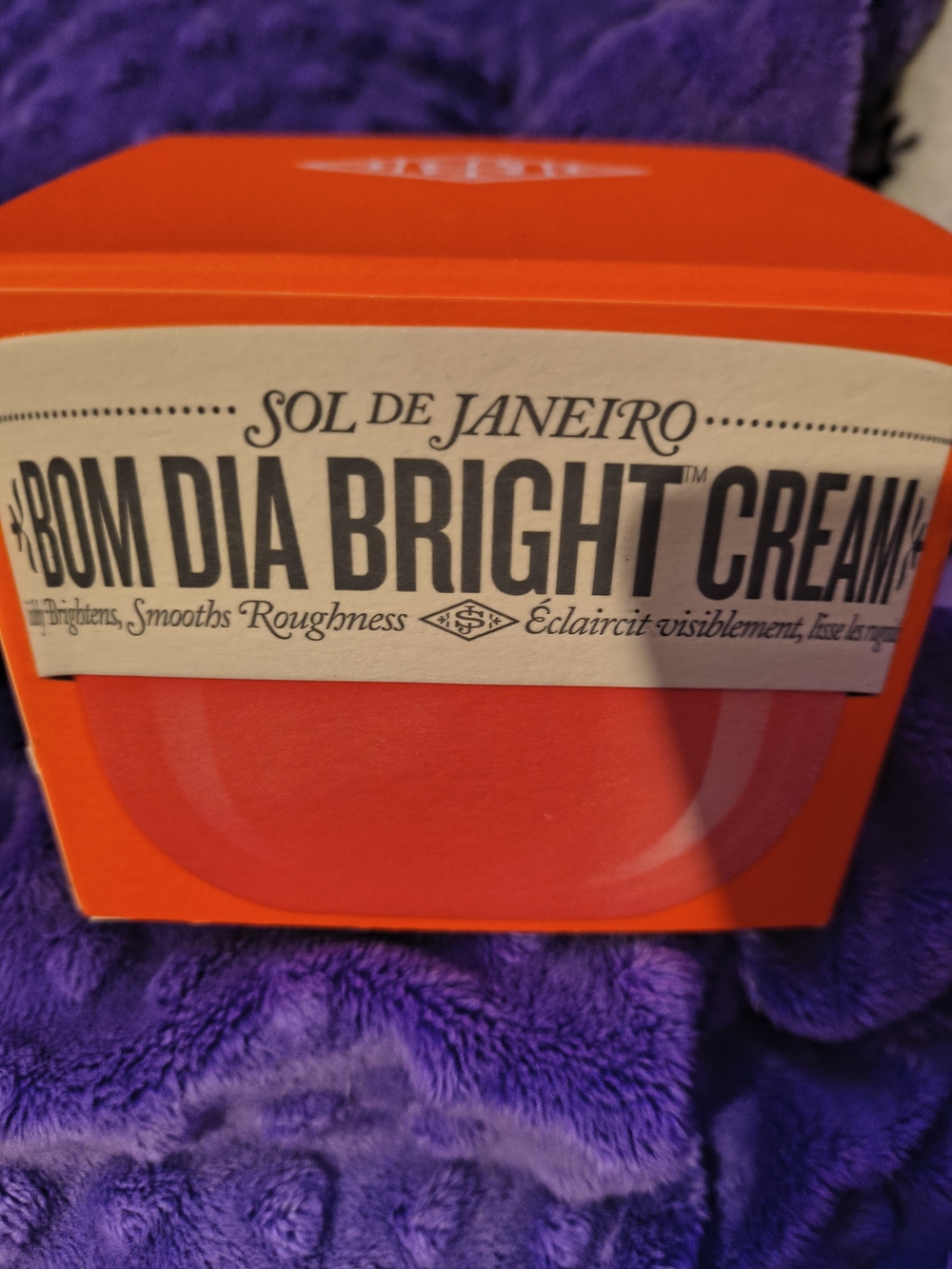 Sol de Janeiro Body Cream in Bright Orange Packaging with Pink Accent